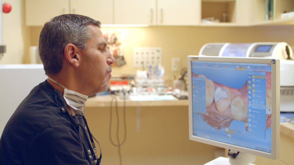 Dr. Butterman using dental technology
